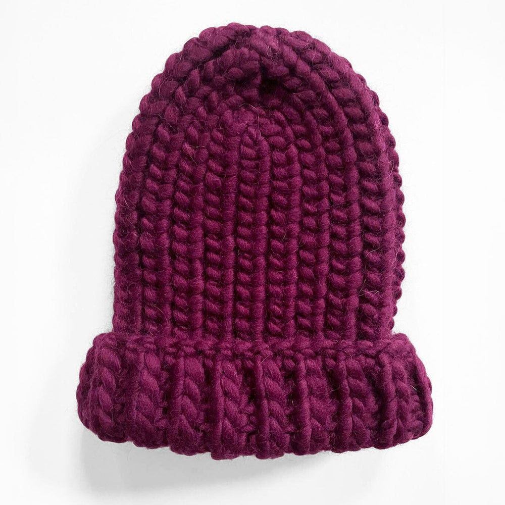 
                  
                    Hand knit wool hat in mulberry. Handmade by artisans in Peru. Designed by M.Patmos.
                  
                