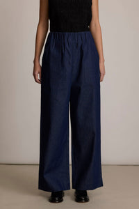 Woman wearing the M.PATMOS Marco Pant in Denim, a modern elastic waistband wide leg trouser with surplus pockets.