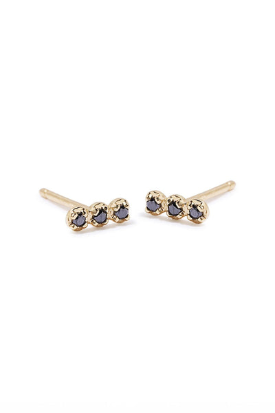 Minimal, everyday 14k gold studs with black diamonds. Available at M.Patmos.