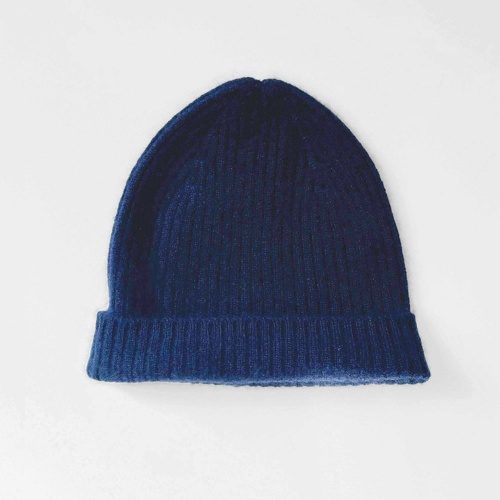 Knit cashmere navy beanie on a white background