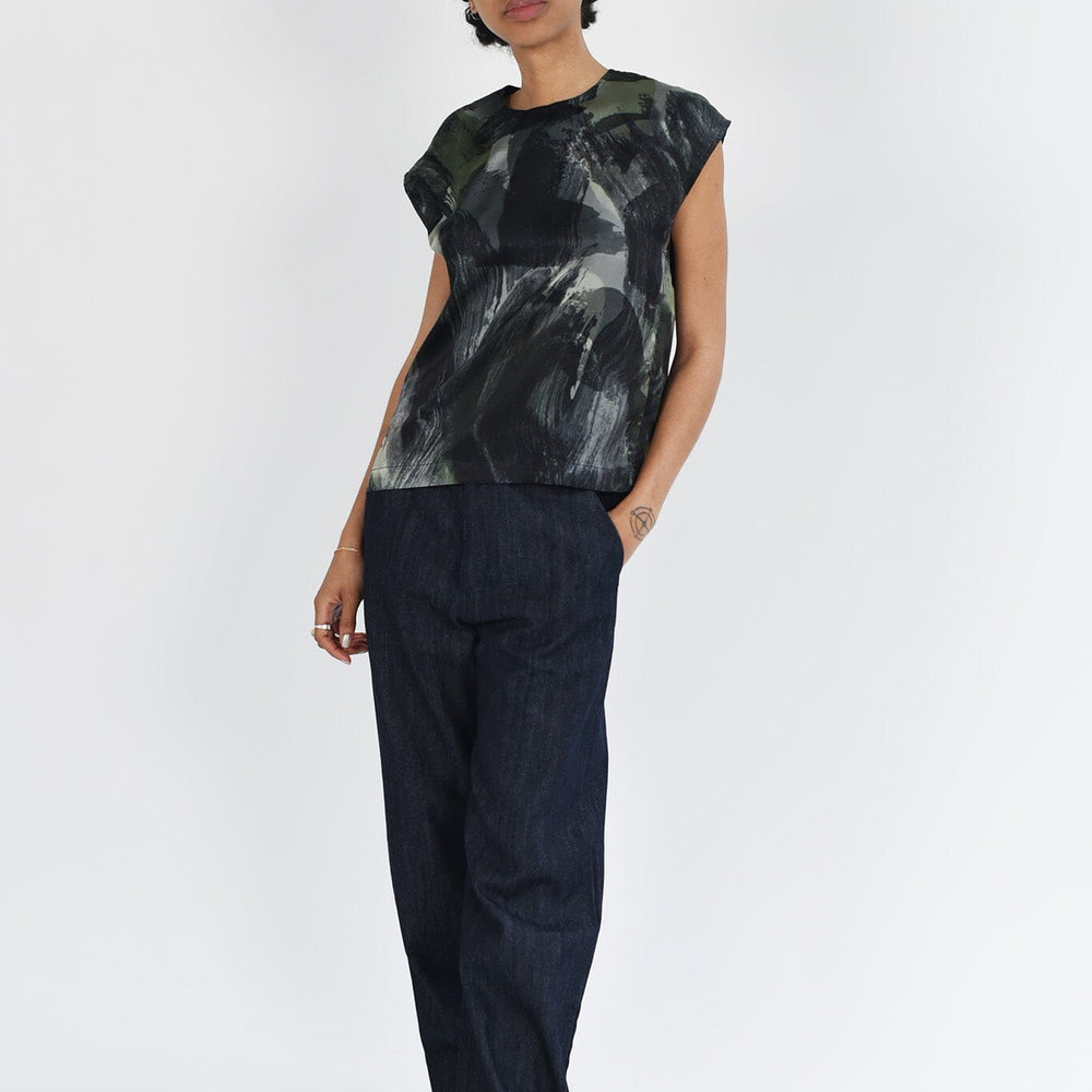 A woman wears the M.Patmos borden silk blouse with a beautiful black and grey watercolor pattern. Designed in Brooklyn, New York.