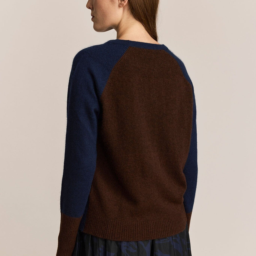 
                  
                    The back of a navy and maroon cashmere and wool long sleeve sweater
                  
                