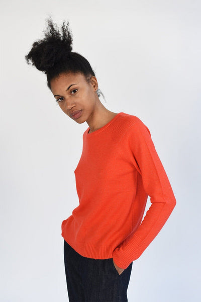 Cozy cashmere sweater in coral orange. Designed by M.Patmos in Brooklyn, New York.