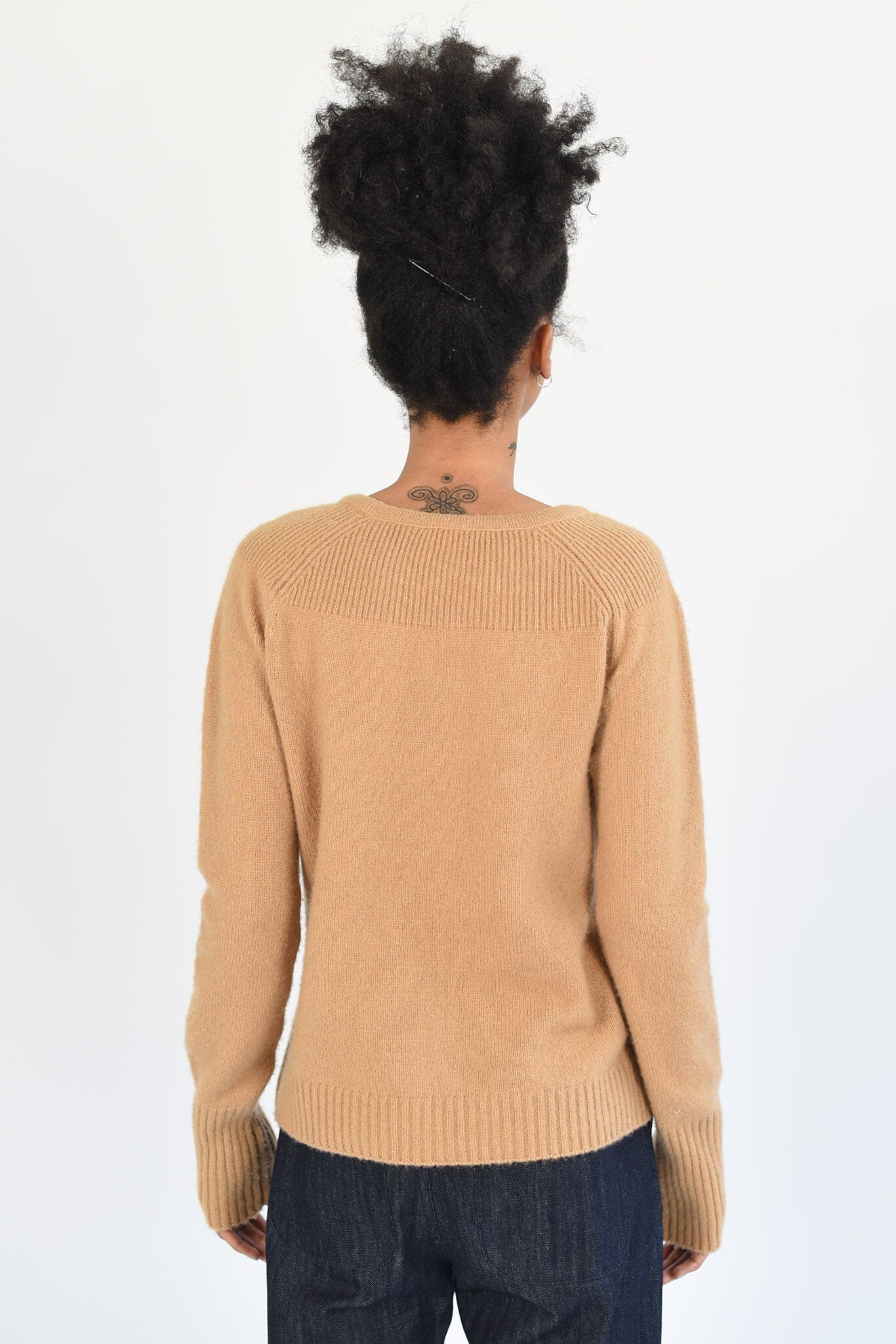 The back view of a long sleeve brown cashmere sweater