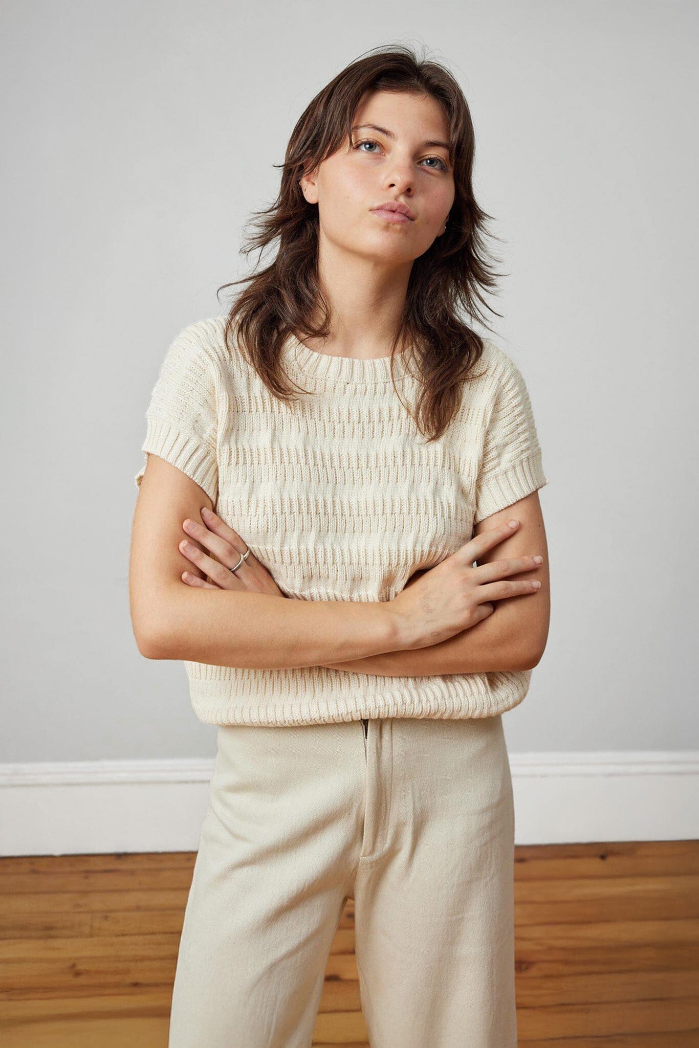 A lightweight, cream, knit short sleeve womens top. Made in Peru.