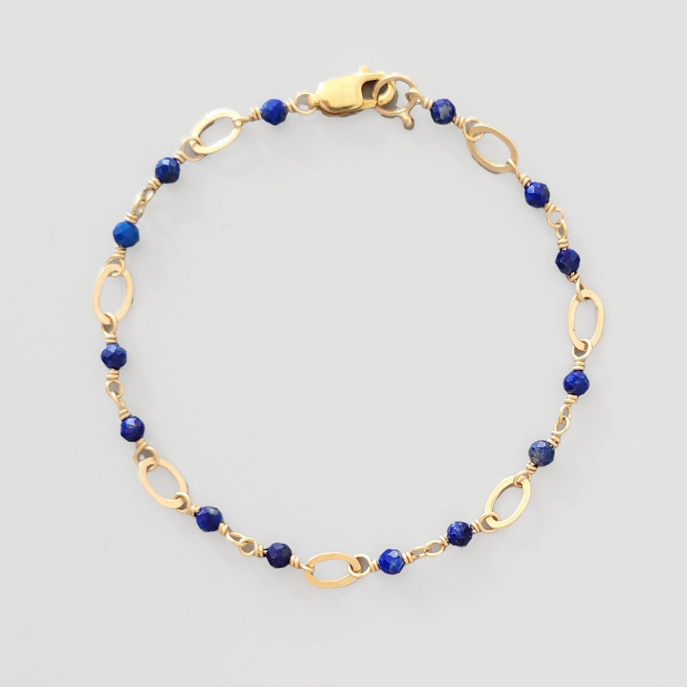 
                  
                    Gold oval and blue lapis beaded bracelet
                  
                
