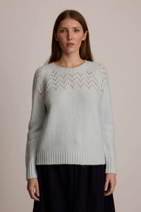 Woman wearing the M.PATMOS Corinne Pullover in Icicle, a merino cashmere raglan sweater with v-eyelet yoke.