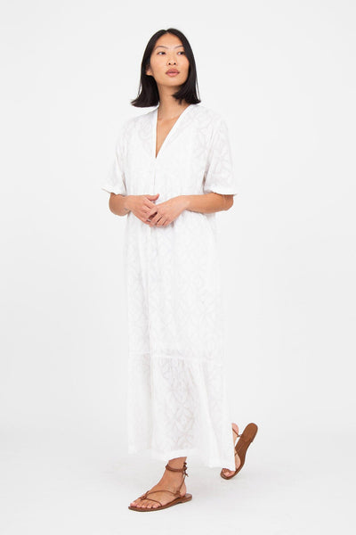 A woman wears the M.Patmos jacquard cotton long Linden dress in white. Designed in Brooklyn, New York.