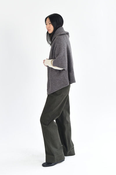 A woman wears the M.Patmos cotton Riverside pants in forest green. Designed in Brooklyn, New York.