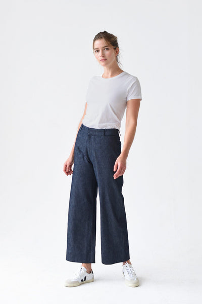 A woman wears a white tshirt paired with the M.Patmos 100% cotton denim Fleet pants. Designed in Brooklyn, New York.