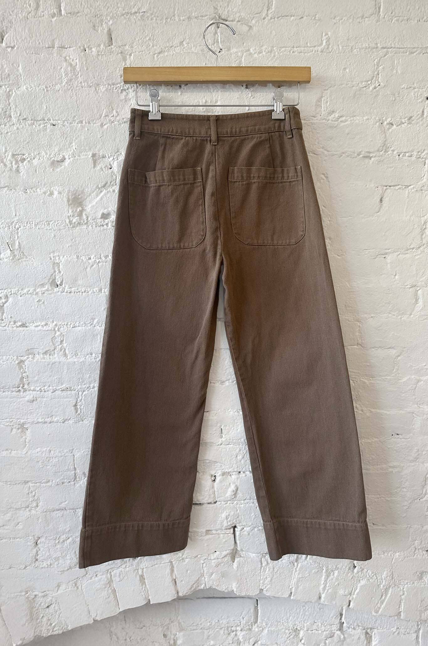 The bac of the chocolate colored denim pants 