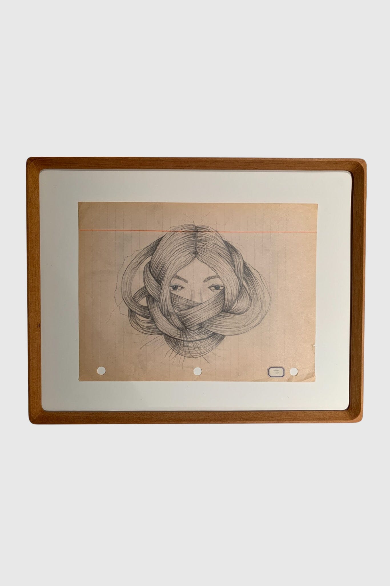 A soft, detailed illustration of a womans head and hair wrapped around her face. Drawn on aged line paper.