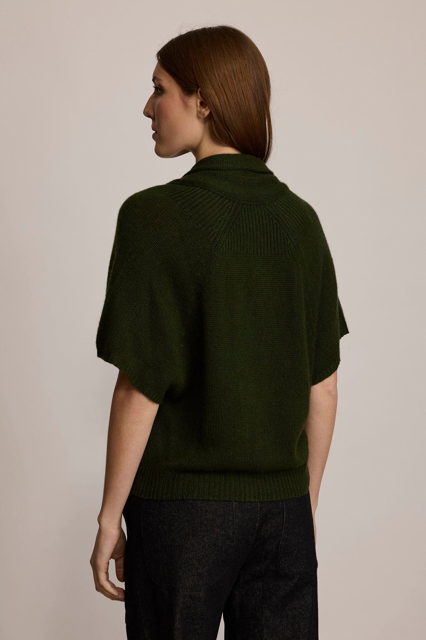 Model wearing M.PATMOS Ilam Cardigan in Forest with a cashmere silk knit, shawl collar and pearl buttons.