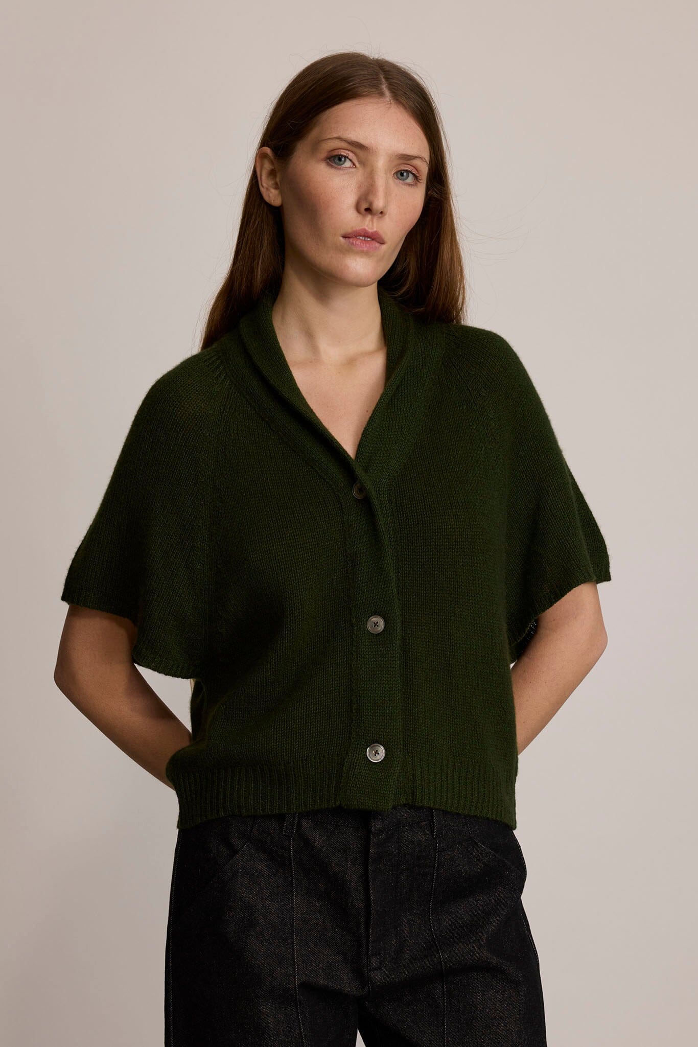 Model wearing M.PATMOS Ilam Cardigan in Forest with a cashmere silk knit, shawl collar and pearl buttons.
