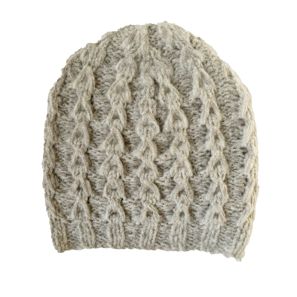 Knitted grey beanie with cable pattern on a white background.