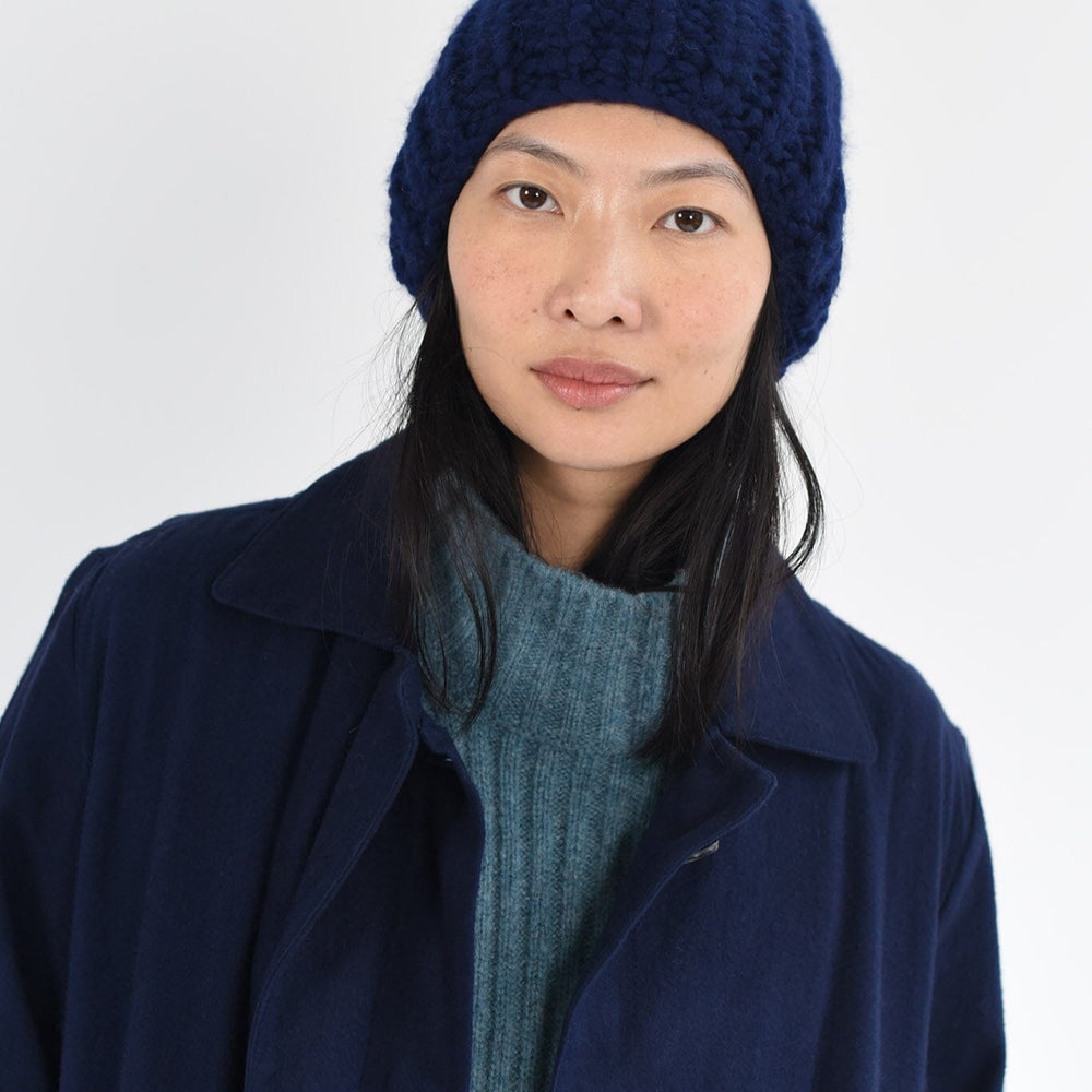 Model wears cozy wool hat in navy.