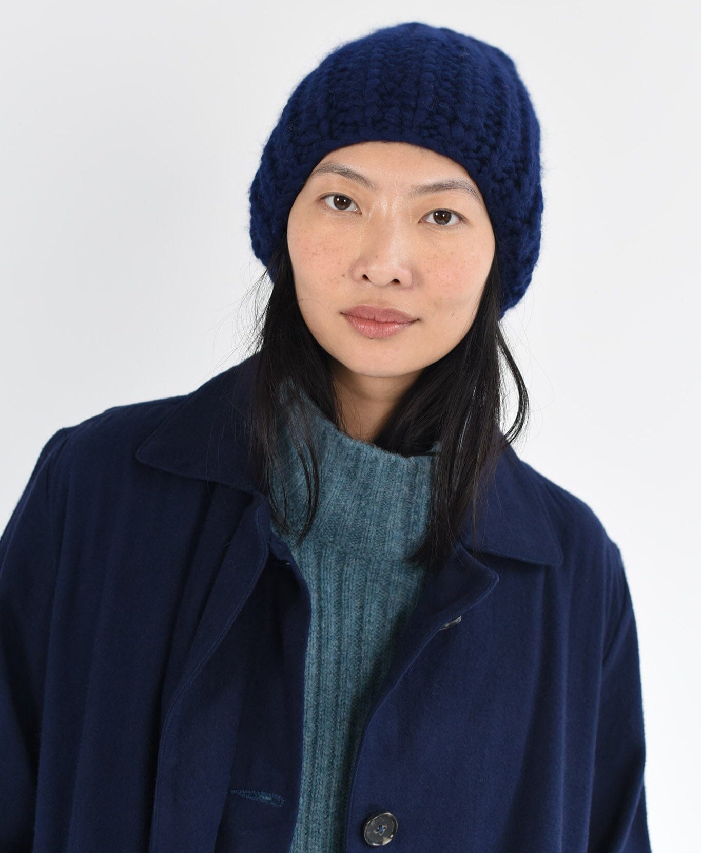 Model wears cozy wool hat in navy.