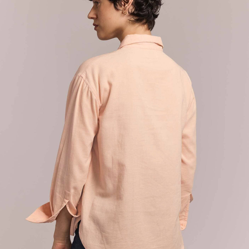
                  
                    Person wearing a light pink cotton shirt against a plain background
                  
                