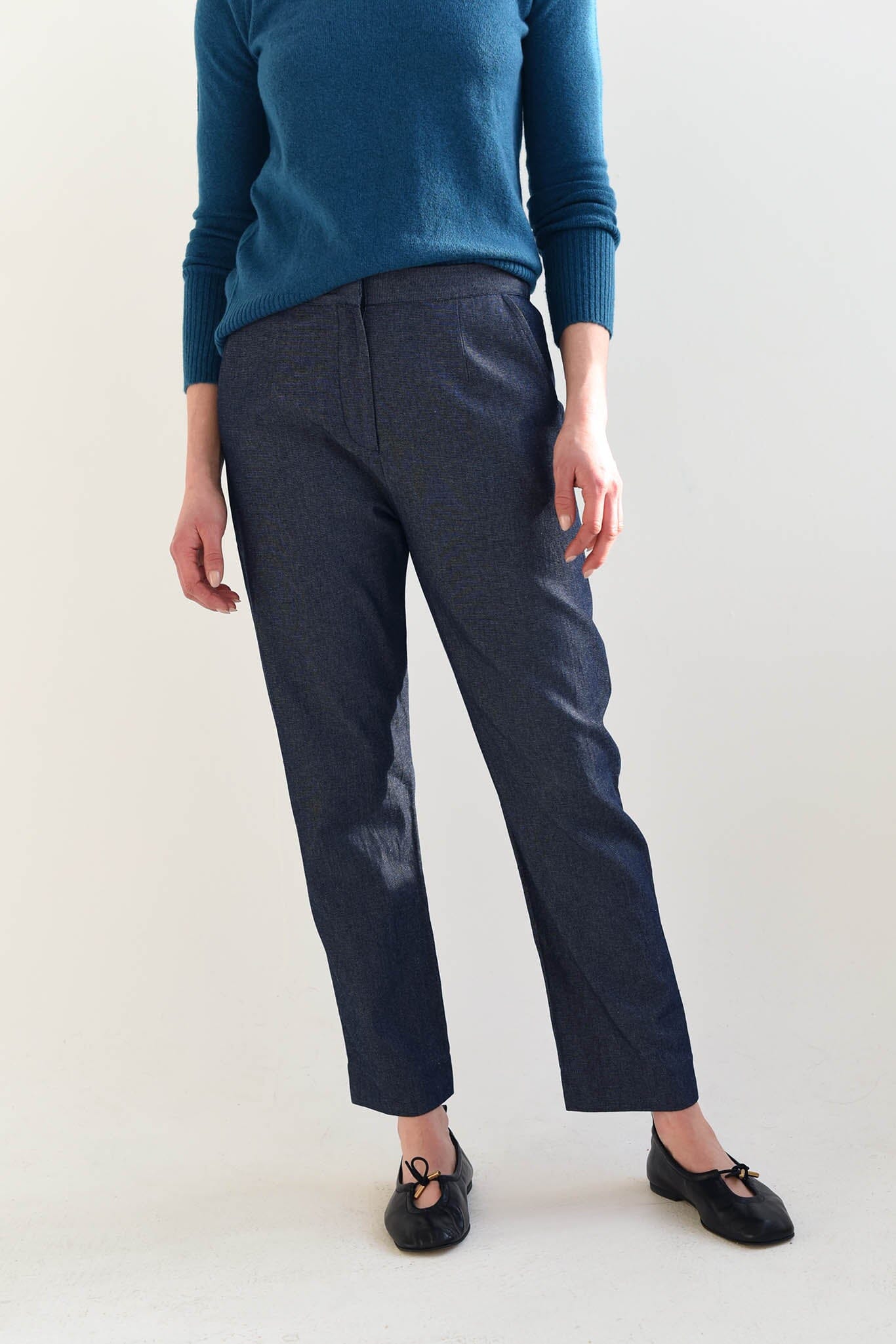 A woman wears the M.Patmos cotton Lou pants paired with black Alohas flats. Designed in Brooklyn, New York.