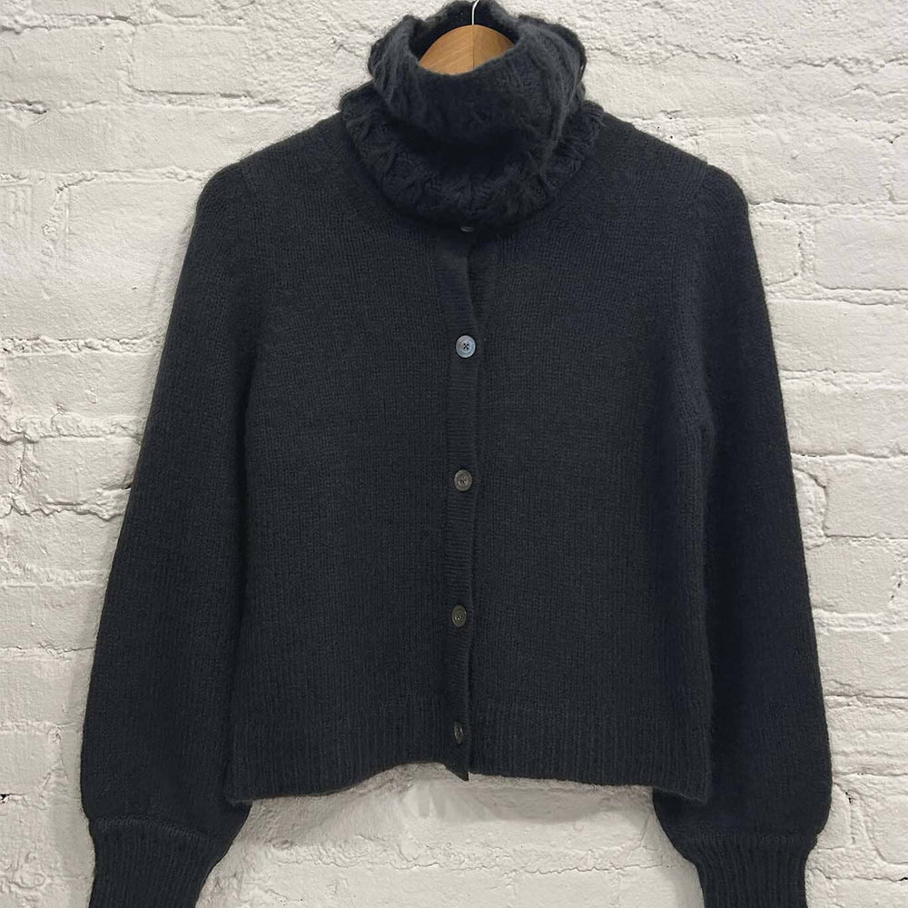 
                  
                    The M.Patmos Lydia sweater paired with the woven wool coal funnelneck scarf
                  
                