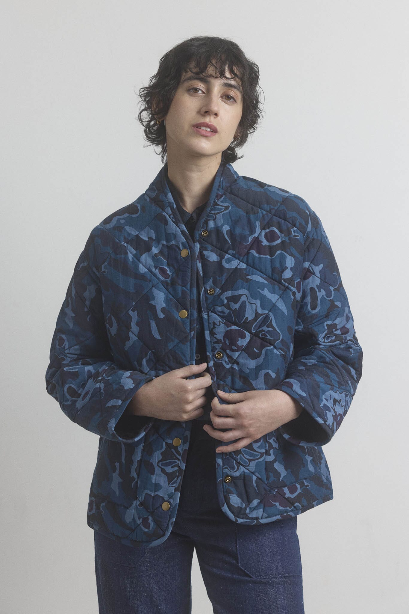Person wearing a cotton and silk blue patterned jacket against a plain background