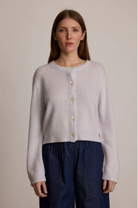 Woman wearing M.PATMOS Serene Cardigan in Dusk. A soft cashmere silk crewneck with mother of pearl buttons.