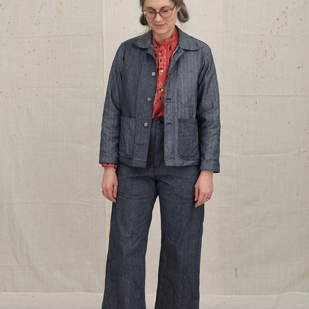 A woman wears the cotton Uqnatu Sailor pants in indigo pinstripe. Available to purchase at M.Patmos in Brooklyn, New York.