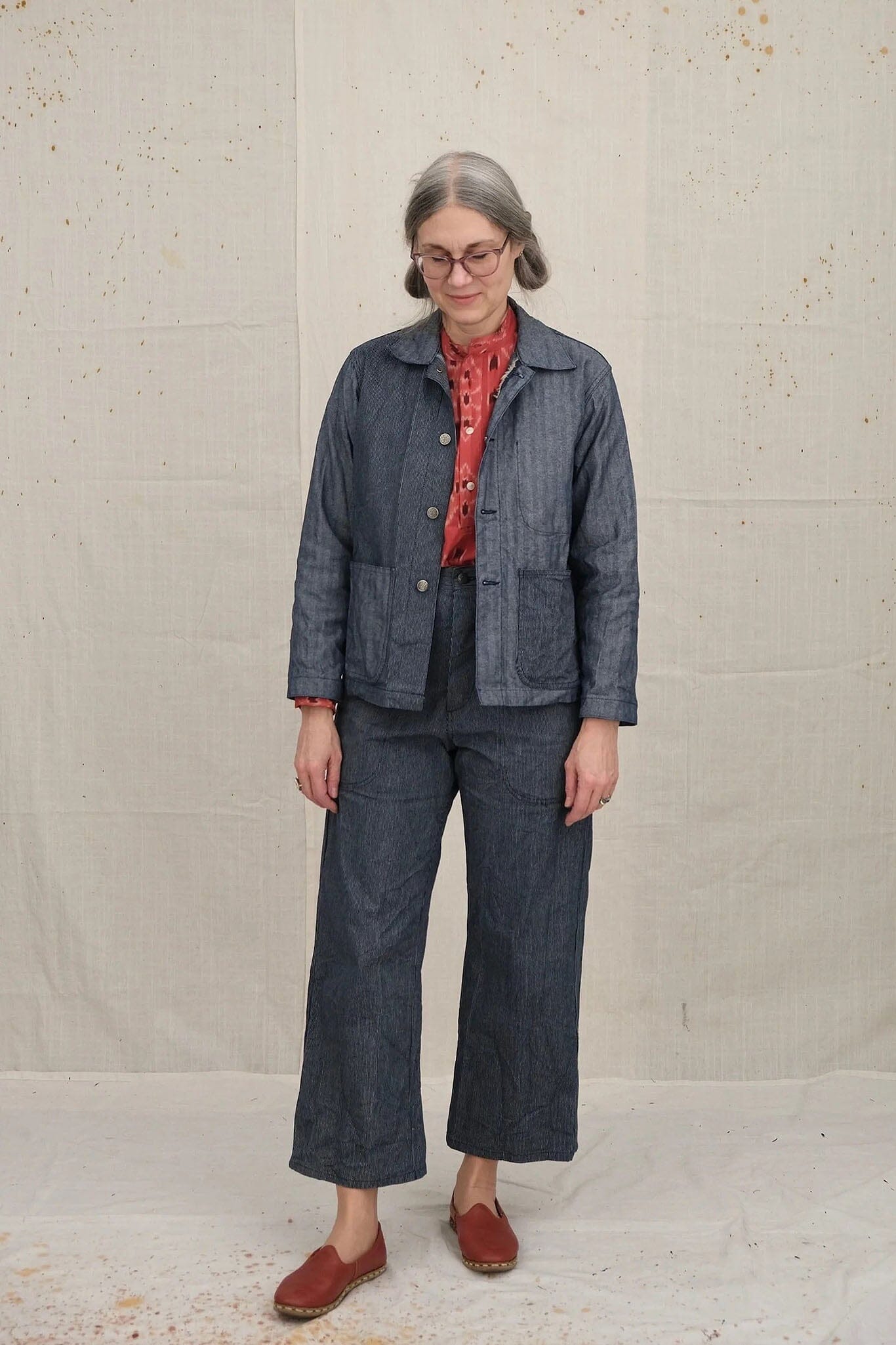 A woman wears the cotton Uqnatu Sailor pants in indigo pinstripe. Available to purchase at M.Patmos in Brooklyn, New York.