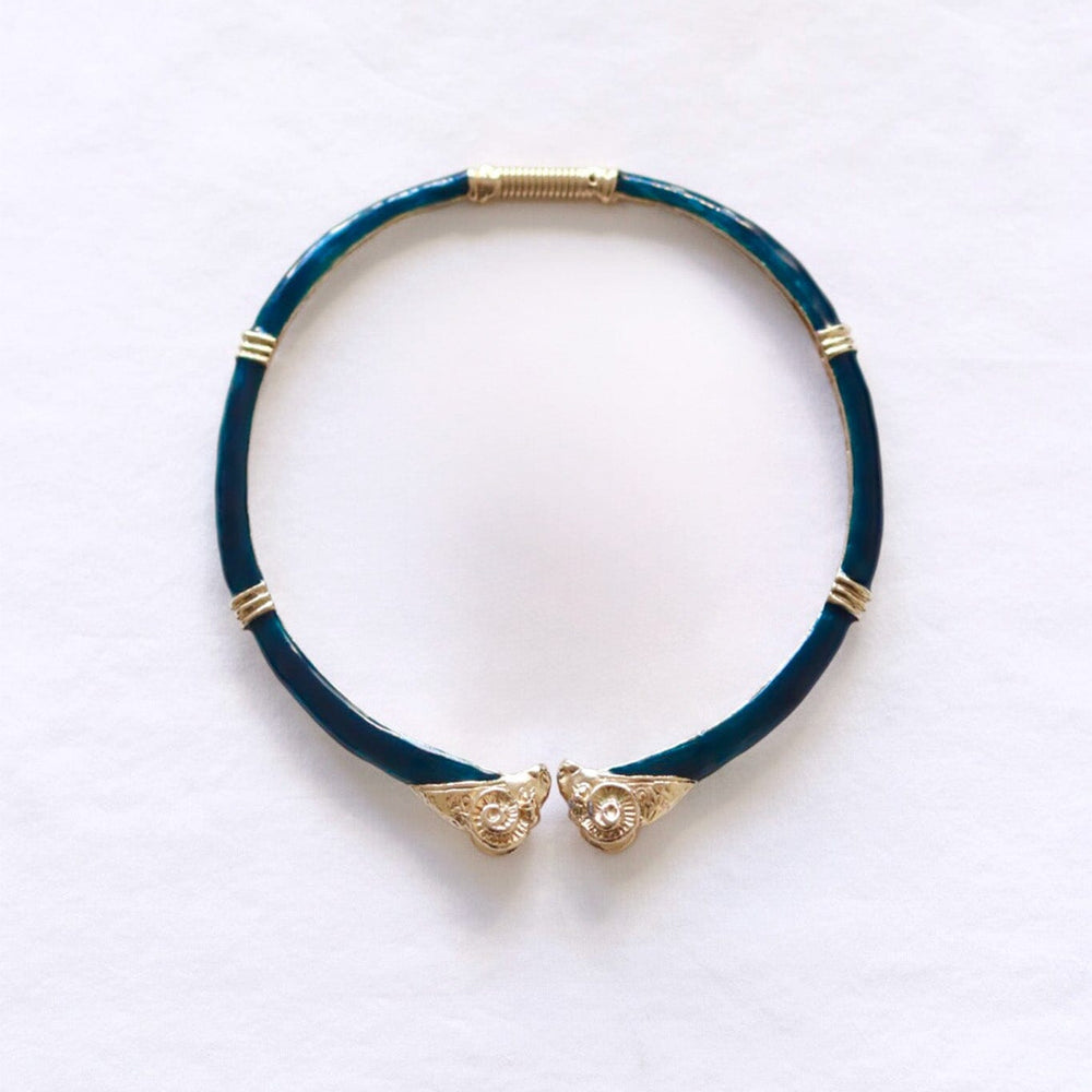 
                  
                    Dark green choker necklace with gold accents on a white background
                  
                