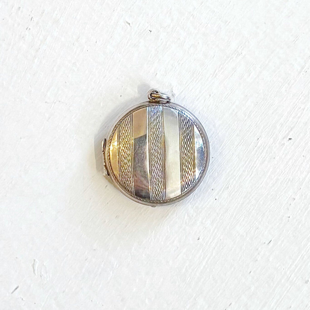 Round silver vintage locket on a white background