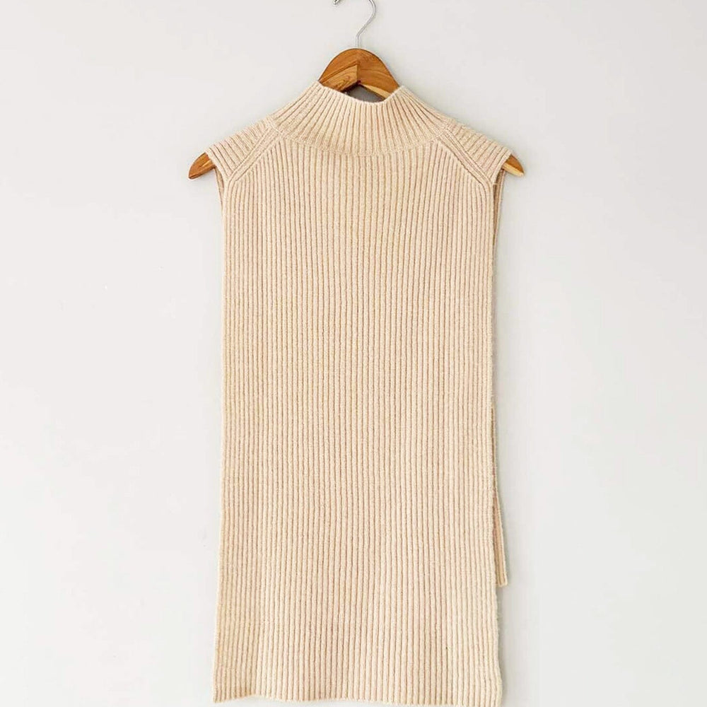 A beige, ribbed wool and cashmere blend vest with a mock funnel neck and high low hemline, displayed on a wooden hanger.