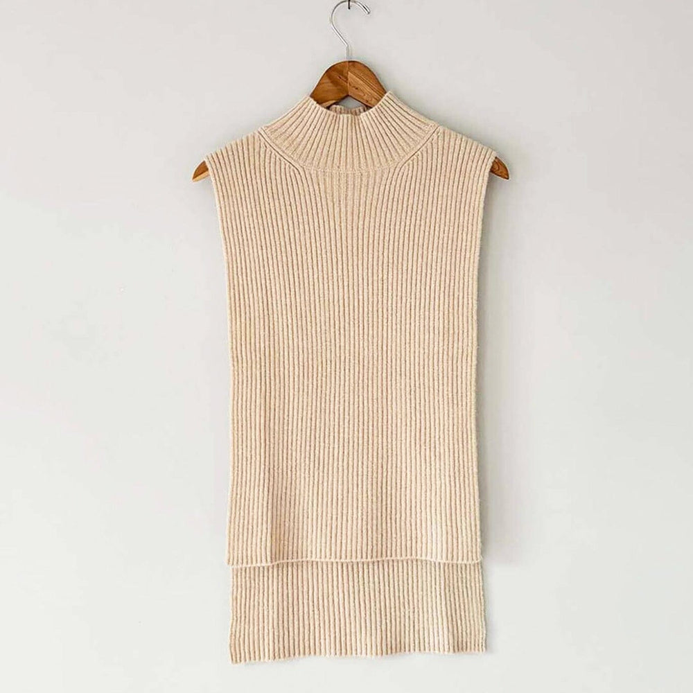 A beige, ribbed wool and cashmere blend vest with a mock funnel neck and high low hemline, displayed on a wooden hanger.