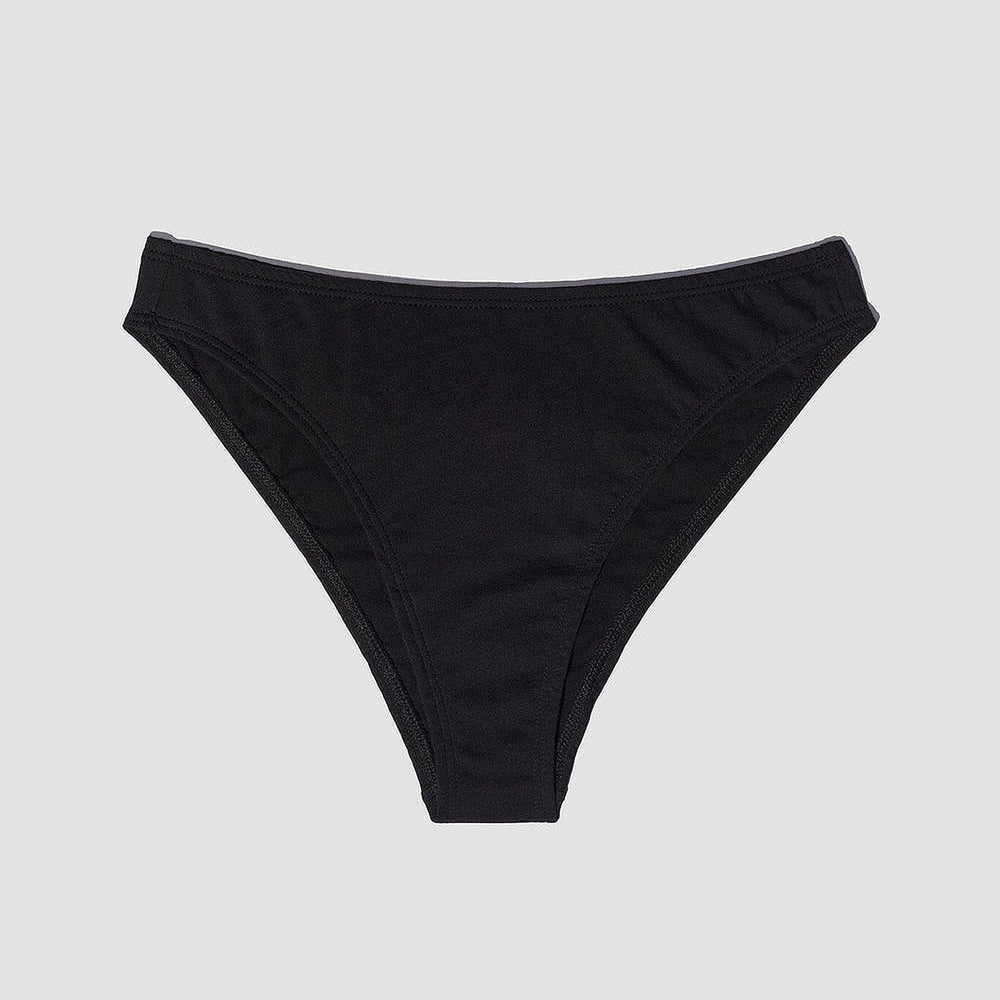 This image features the Oddobody Mid Rise French Cut panty in black, highlighting its sleek and elegant design. The panty is crafted with a comfortable mid-rise waist and a high-cut silhouette that emphasizes a flattering, nostalgic flair reminiscent of 1980s cotton underwear styles.