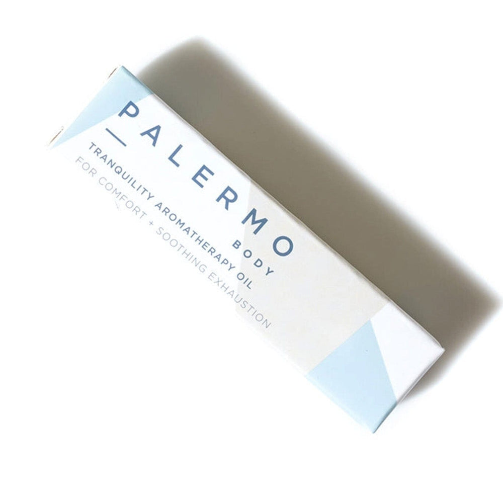 
                  
                    A white and blue package holding a roll-on bottle of Tranquility Aromatherapy Oil by Palermo Body
                  
                
