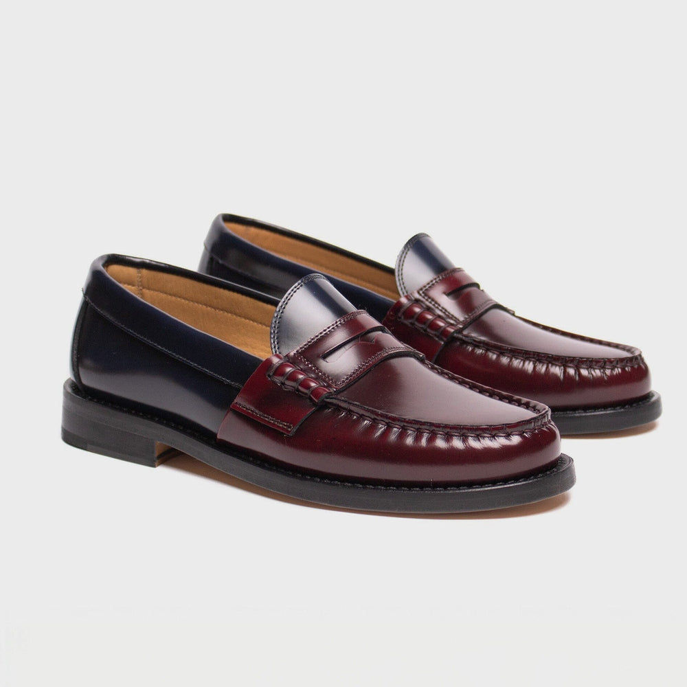 Pair of maroon loafers on a light gray background