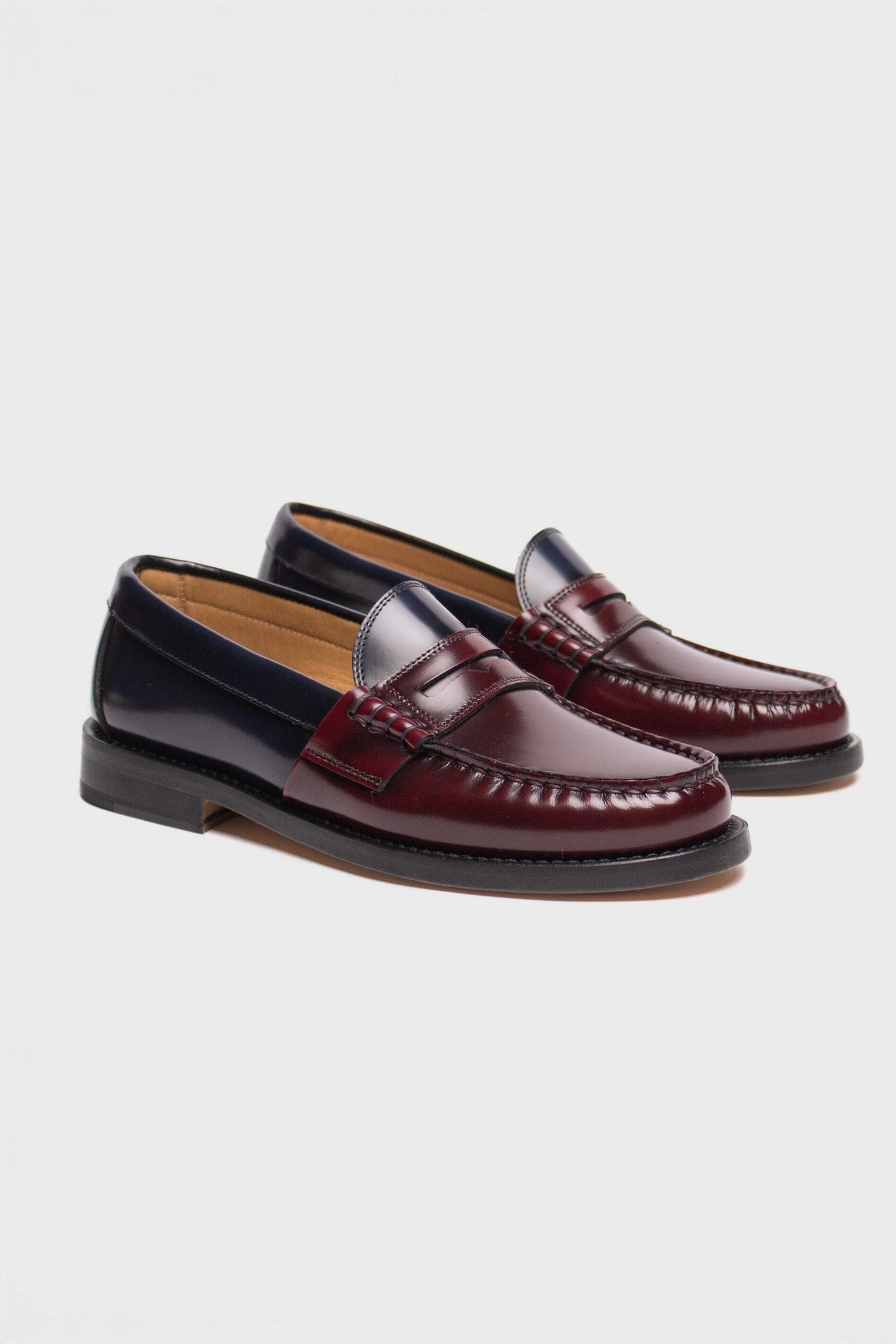Pair of maroon loafers on a light gray background