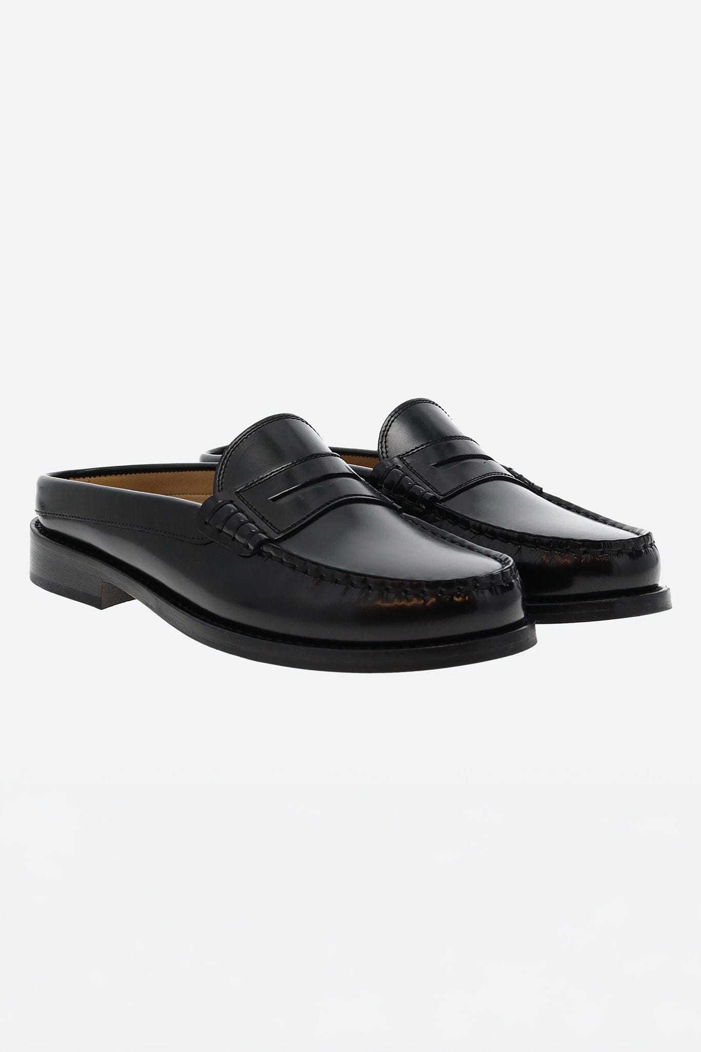 Pair of black slipper loafers on a white background