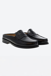 Pair of black slipper loafers on a white background