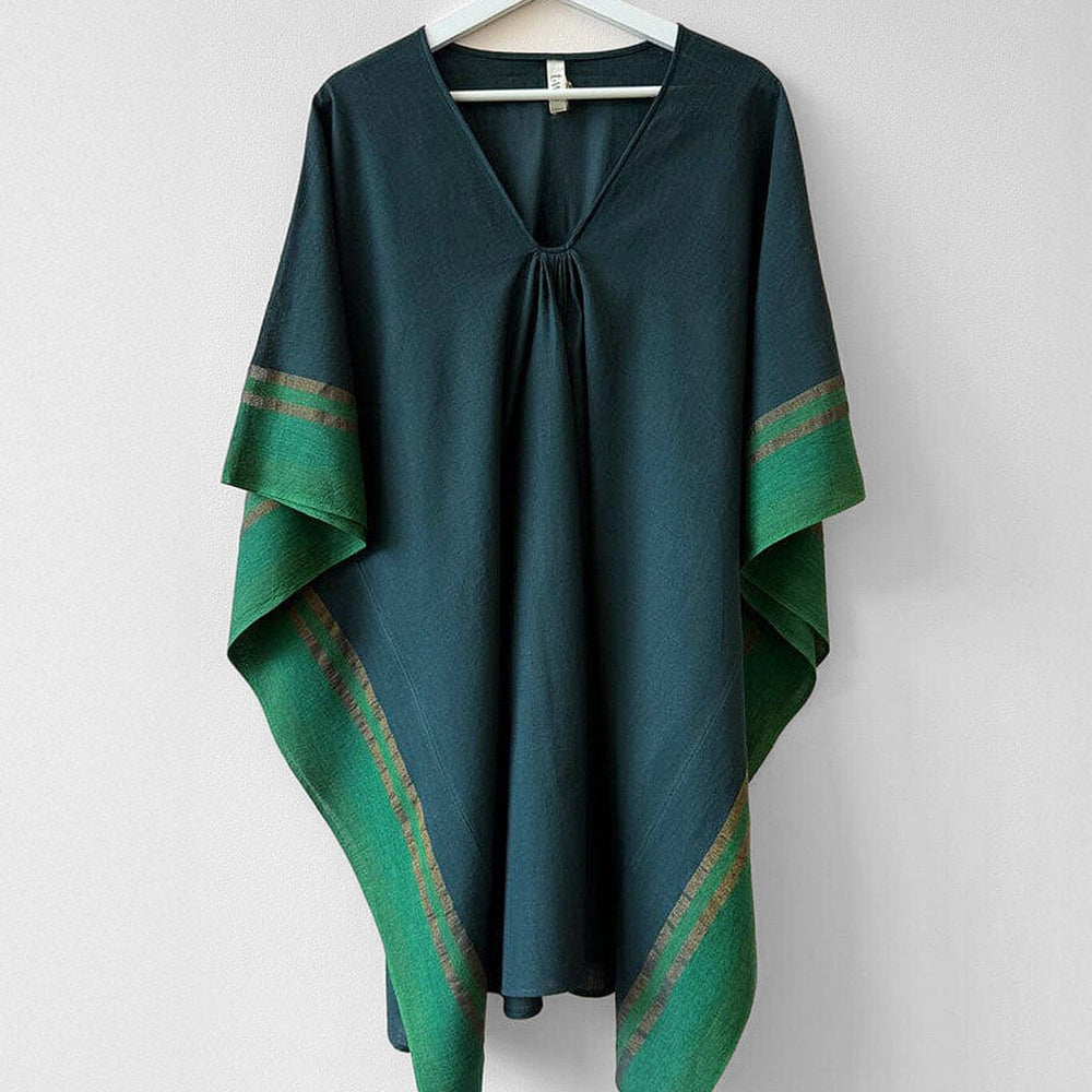 Green tunic with green patterned trim on a white hanger against a white background