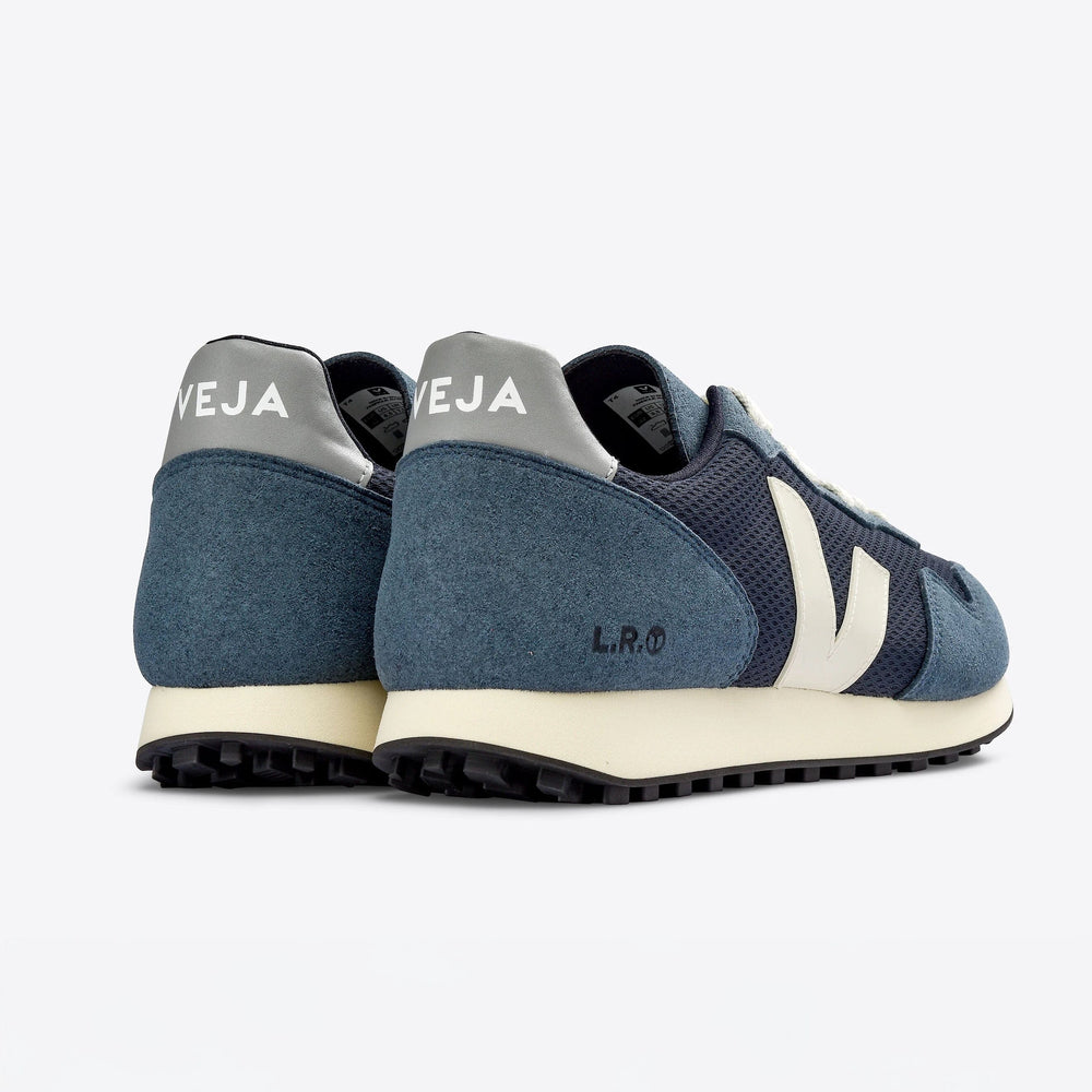 
                  
                    The back view of blue and white Veja SDU Alveomesh sneakers with mesh paneling and a lace-up closure.
                  
                