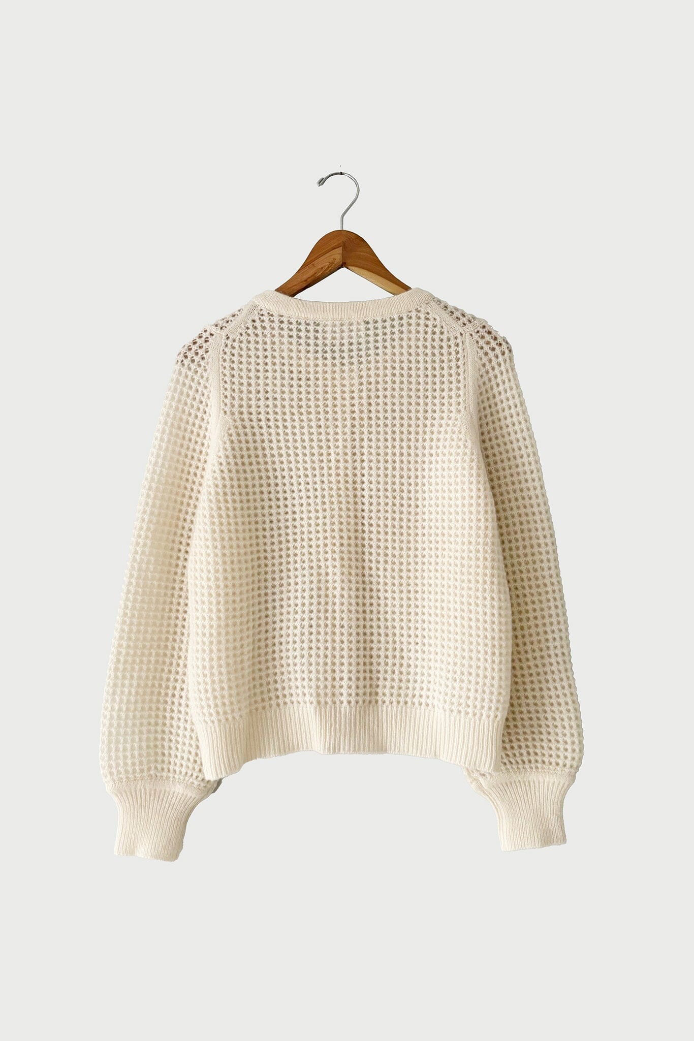 The large Devin Mesh Cardigan in Ivory by M.Patmos is a  lightweight women's cardigan with an elegant mesh design, perfect for year-round layering.