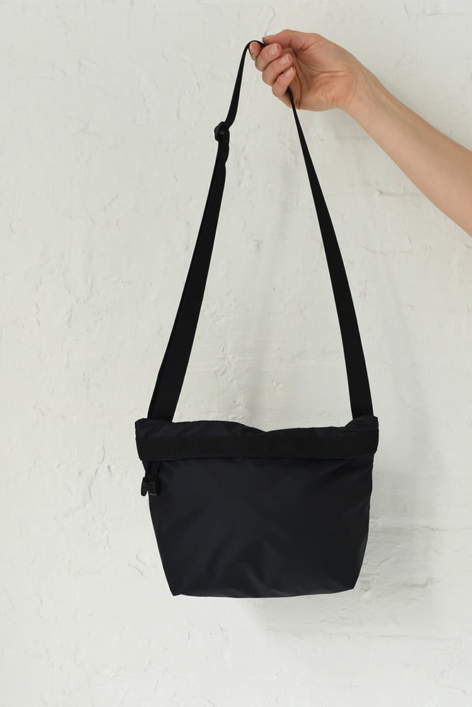 
                  
                    A black crossbody bag with an adjustable shoulder strap
                  
                