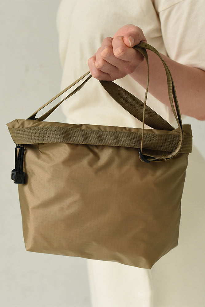 A brown nylon crossbody bag.