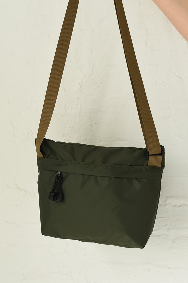 An army green and olive colored crossbody nylon bag