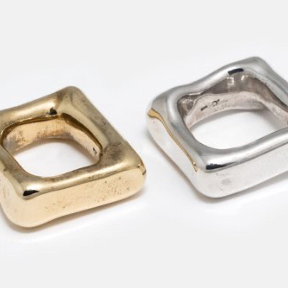 A solid heavy brass and silver square band ring, handmade, with a glossy finish.