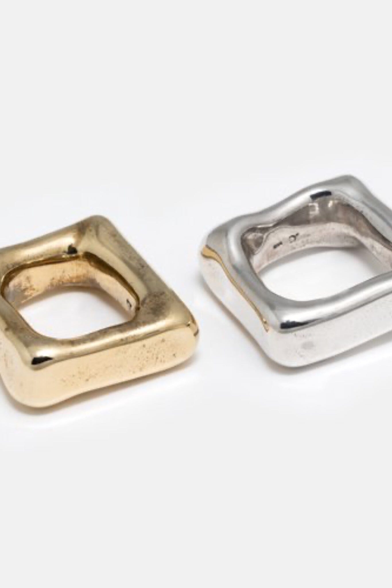 A solid heavy brass and silver square band ring, handmade, with a glossy finish.