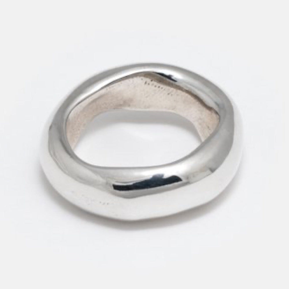 A thick silver band ring with a smooth, heavy metal organic design.