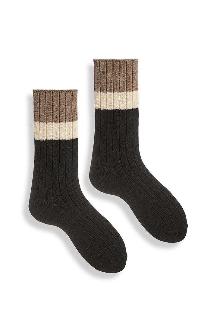 A pair of color block crew socks with black as the dominant color, featuring cream and brown blocks at the top.