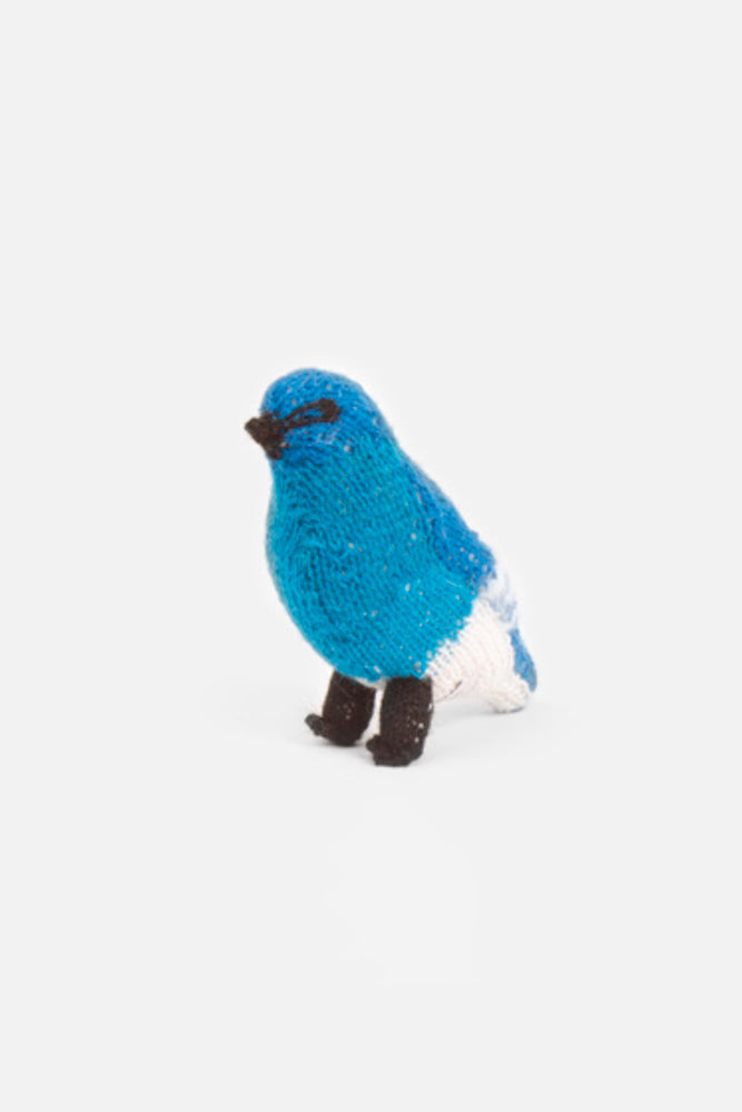 A handmade stuffed wool blue bird toy