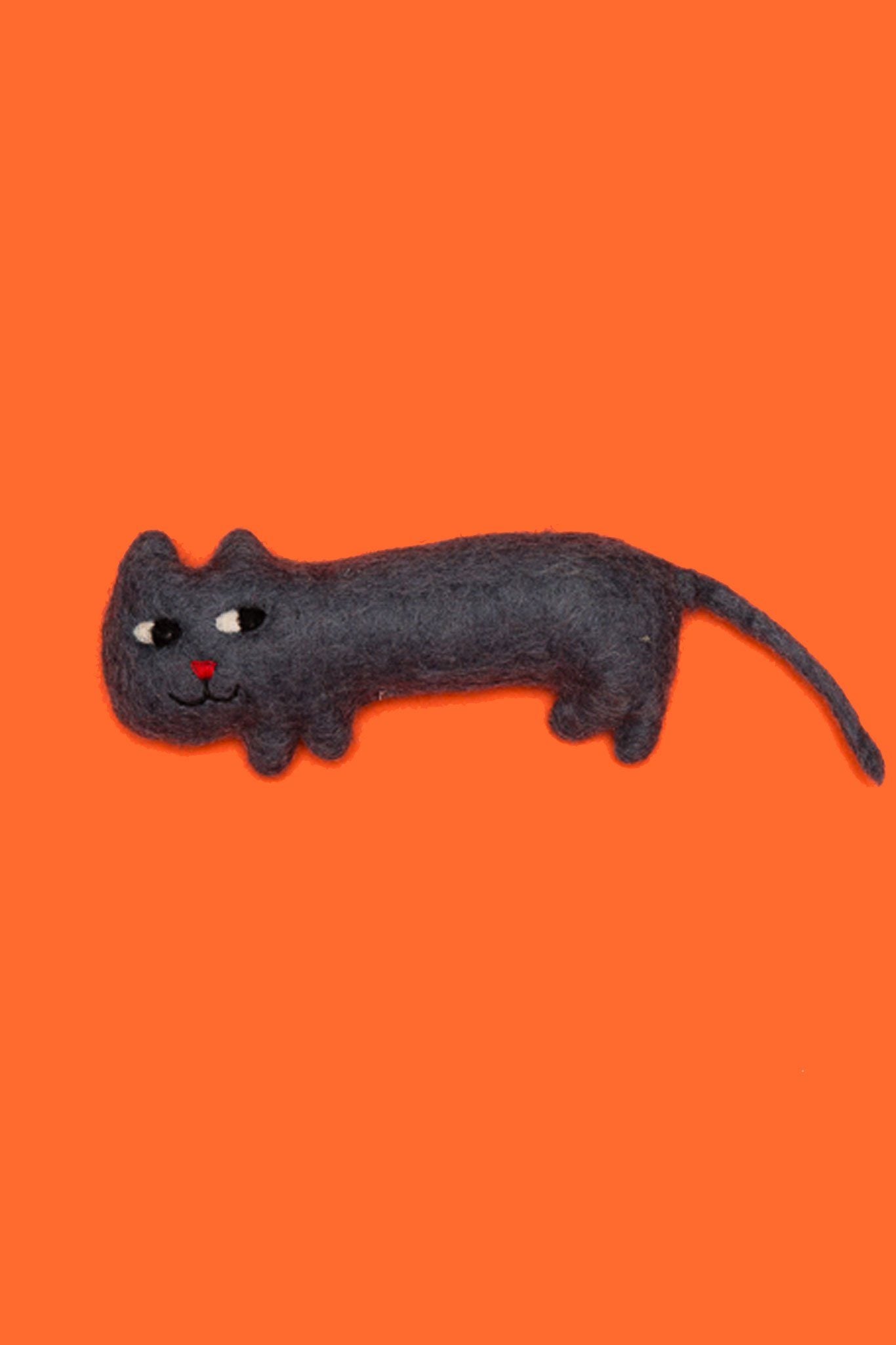 A black felted wool dog toy with a orange background
